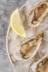 Fresh raw oysters on ice with lemon