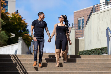 Young African American lesbian couple holding hands outside