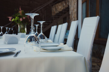 Rustic table setting with purple flowers and glass of red wine on light wooden table. Holidays...