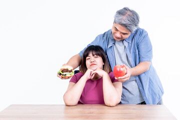 Portrait images of Asian couple, The husband delivered hamburgers and apple for his wife to choose...