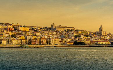 The old quarter of Lisbon, Portugal viewed from the river Tagus in the early morning light at sunrise in Autumn
