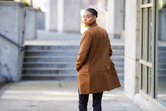 Young African American walking away and looking over her shoulder