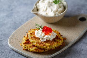 Hash Browns with Sour Cream, Dill and Red Caviar. Potato pancakes