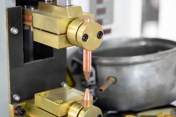 Copper electrodes of spot welding machine at factory, plant - close up. Metalworking, industrial, equipment, technology, machining, manufacturing concept