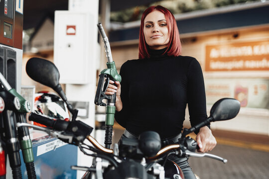 Sunny vintage photo of girl which rides her urban bike in service. Custom motorcycle and its female onwer. Female biker.