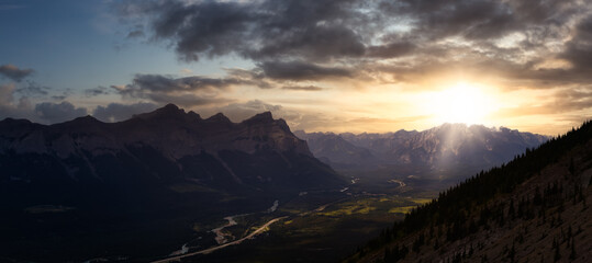 Beautiful Panoramic View of Canadian Rocky Mountain Landscape. Dramatic Colorful Sunset. Taken from Mt Lady MacDonald, Canmore, Alberta, Canada.