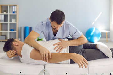 Chiropractor, osteopath, physiotherapist or manual therapist working with male patient