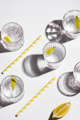 Mineral water with lemon on white background. Hard light