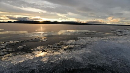 Ice piling up on the lake shore of a lake in Yukon Territory that is ready to freeze for the long, harsh and bitterly cold winter in northern Canada. - Powered by Adobe