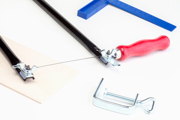 Manual jigsaw for cutting wood isolated on white background, jigsaw. Carpentry hand tools. Plywood...