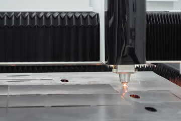Automatic cnc laser cutting machine working with sheet metal at factory, plant. Metalworking,...