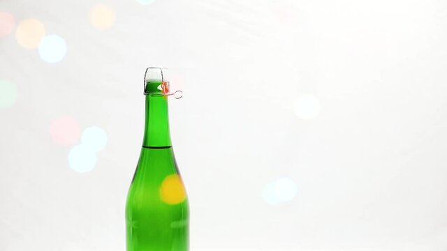 Man in a white shirt opening champane for merry christmas or new year