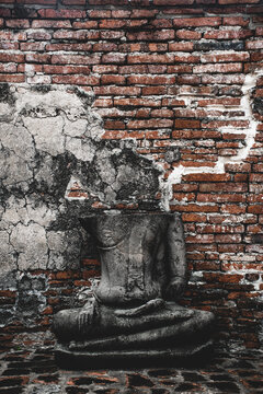 Vertical image of broken Buddha statue at Ayutthaya historical park of Wat Mahathat.