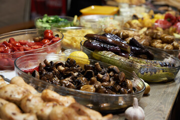 Fried vegetables in dishes on the table, street food