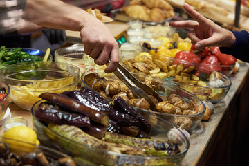 Fried vegetables in dishes on the table, street food