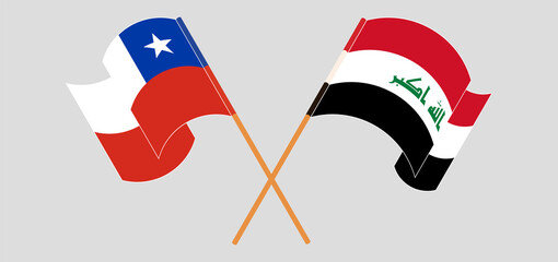 Crossed and waving flags of Chile and Iraq