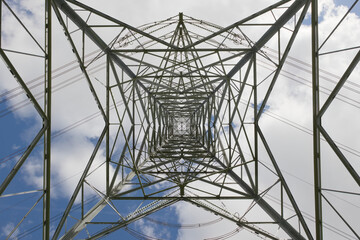 Overhead power lines turn on a tall pylon, part of the national grid