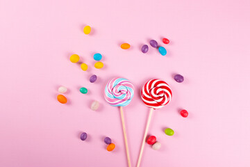 yummy sweet colour round lollipops on the pink background. minimalism style. 