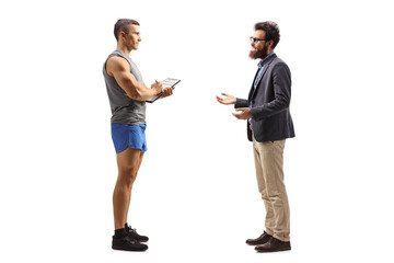 Fototapeta premium Full length profile shot of a bearded man talking to a fitness instructor