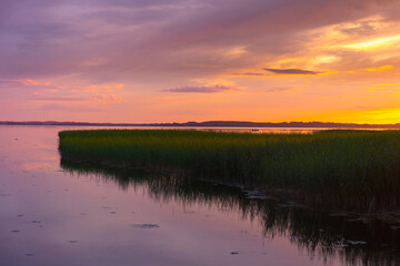 Beautiful colorful sunset over the lake summer landscape.