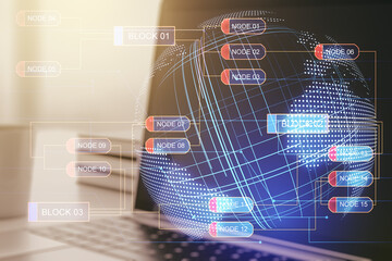 Multi exposure of abstract software development hologram with world map on laptop background, global research and analytics concept