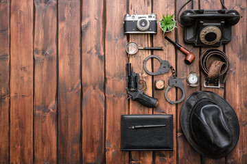 Detective agent equipment on the desk flat lay concept background.