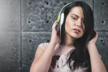Sexy brunette with the headphones. music concept