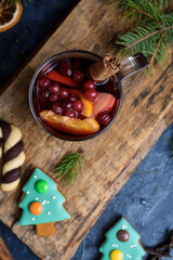 Hot Mulled Wine for winter and Christmas on wooden table with copy space. Red Hot wine. Christmas tree gingerbread