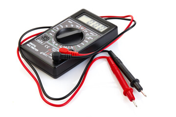 Digital electrical tester multimeter in black case isolated on white background. Digital multimeters have a numeric display, can measure voltage, current and resistance. Close-up. Velective focus