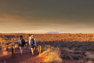 Northern Territory, Australia - Hikers in the Australian outback admiring the spectacular landscape.