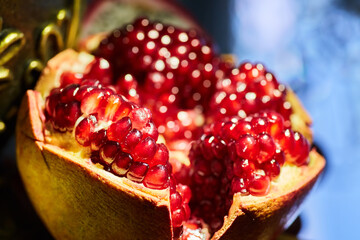 Fruit red ripe pomegranate, cut into slices. Vegetarian diet.