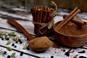 Bunch of cinnamon sticks on a white wooden table