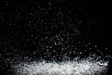 Snowflakes particles isolated on black background. Abstract template for design