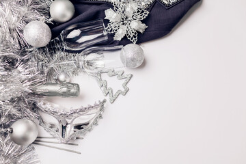 Christmas and New Year white background with champagne, silver and golden decorations. Party masquerade celebration