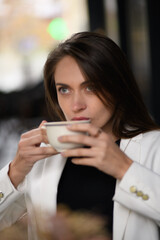 woman drinking coffee in cafe