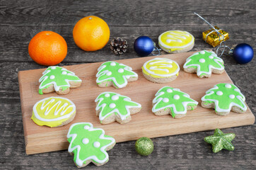 Glazed Christmas cookies on a cutting Board. Old wooden background, selective focus