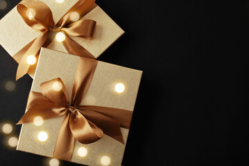 christmas gift box. golden gift boxes with bows and ribbons on elegance black background