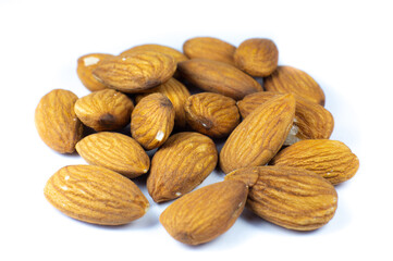 Almond nuts lying on white background. Healthy sport food. Vegan concept. Close up.