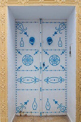 Traditional old door in medina district of Hammamet town, Tunisia. Typical ornament and architecture details for North Africa