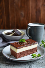 Cocoa bars with white chocolate and whipped cream filling, topped with dark chocolate glaze