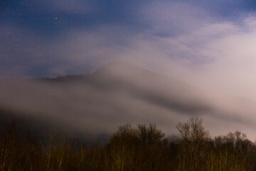 Beautiful landscape with cloudy mountain at twilight