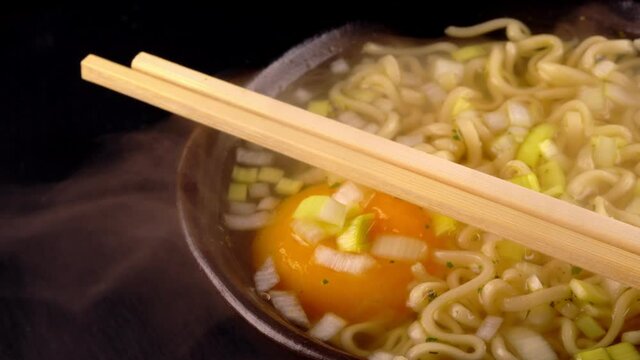 Hot noodle soup with egg and leek.