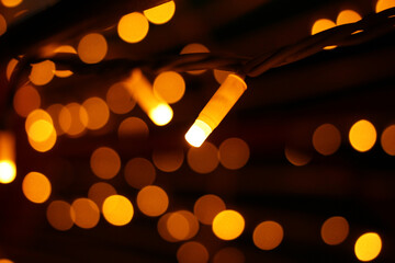 Fototapeta premium Magic lights of a street electric garland in the dark.