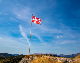 pole with templar flag in the French Riviera back country in summer