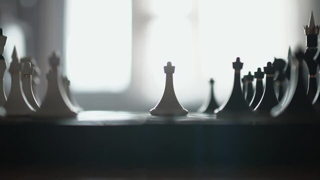 A pawn knocks down a Queen on a chessboard