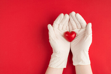 Medical donations concept. Top above overhead view photo of female hands in white gloves holding...