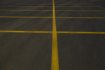 yellow lines in the big black asphalt international way, asphalt parking area, car park 