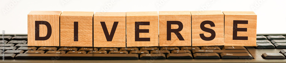 Poster diverse word made with building blocks on the black keyboard