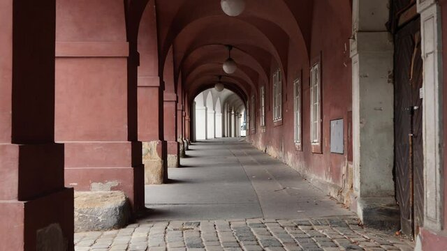 Walking under arches of old buildings near Prague Castle glide shot