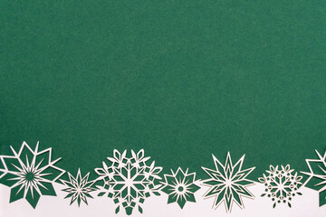 Green Christmas background with white snowflake border